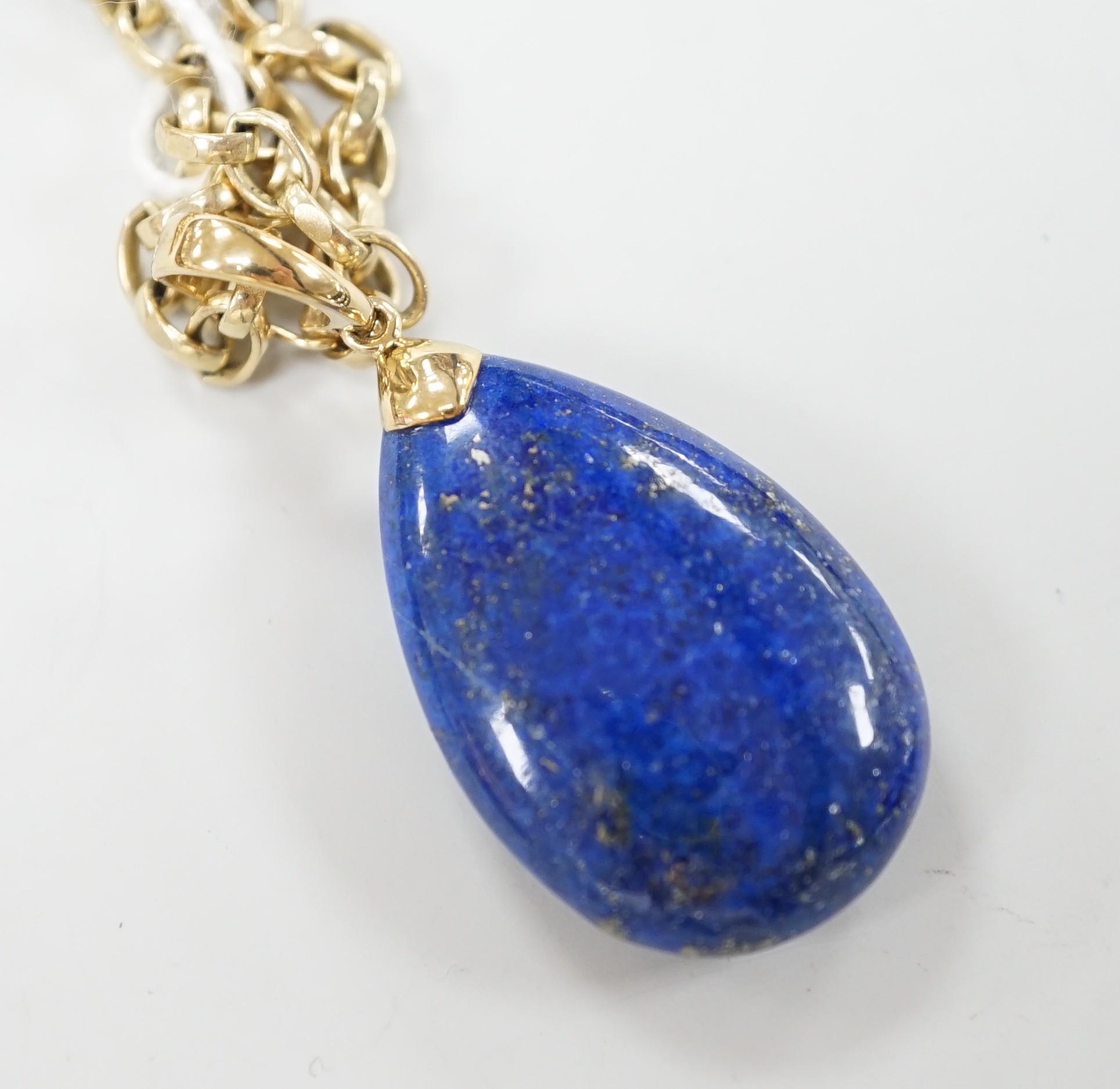 A modern 9k mounted lapis lazuli pendant, 35mm, on a 375 chain, 48cm, chain, 18.5 grams.